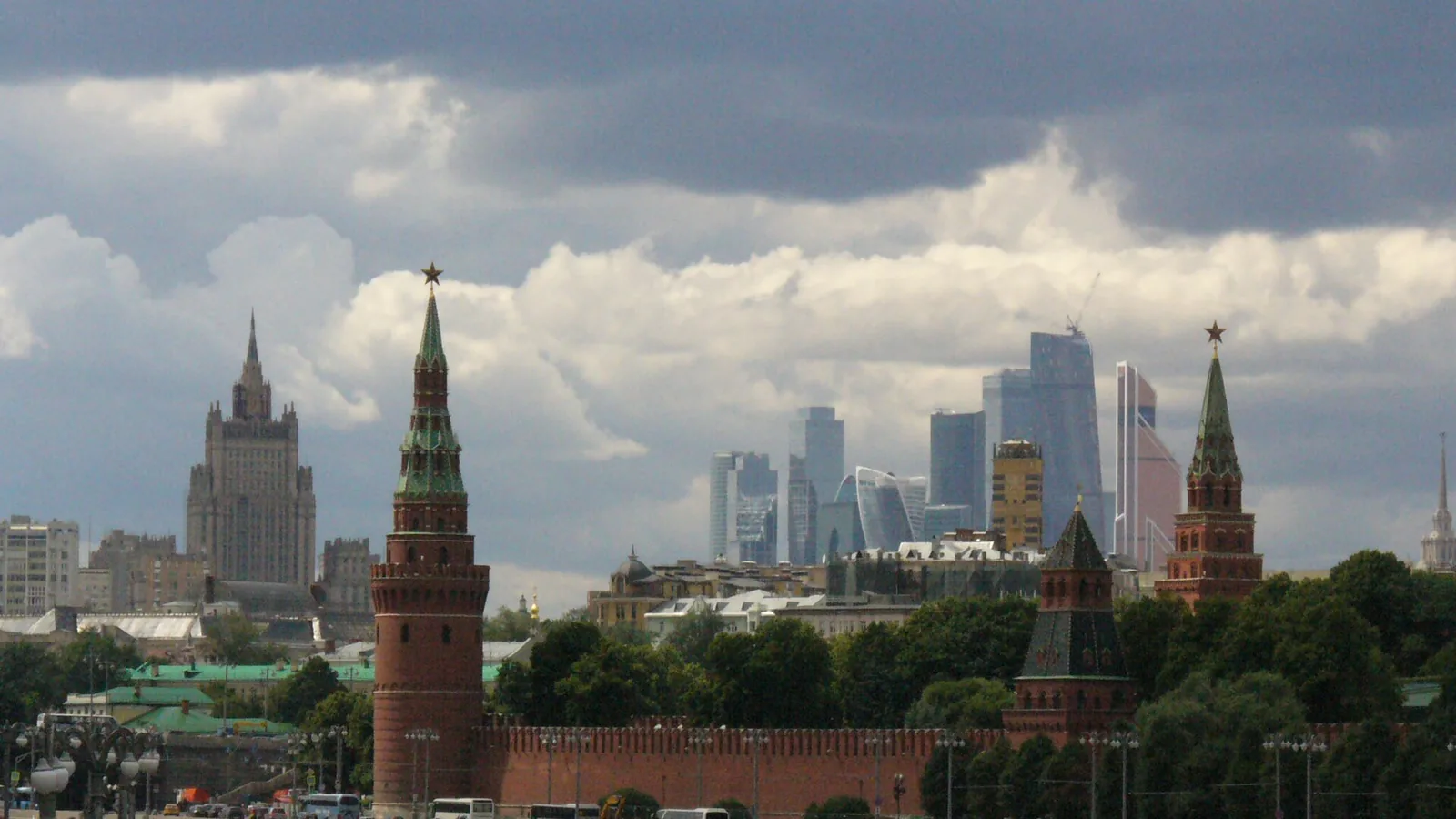 Moscow skyline with the Kremlin towers and modern high-rises under large summer clouds