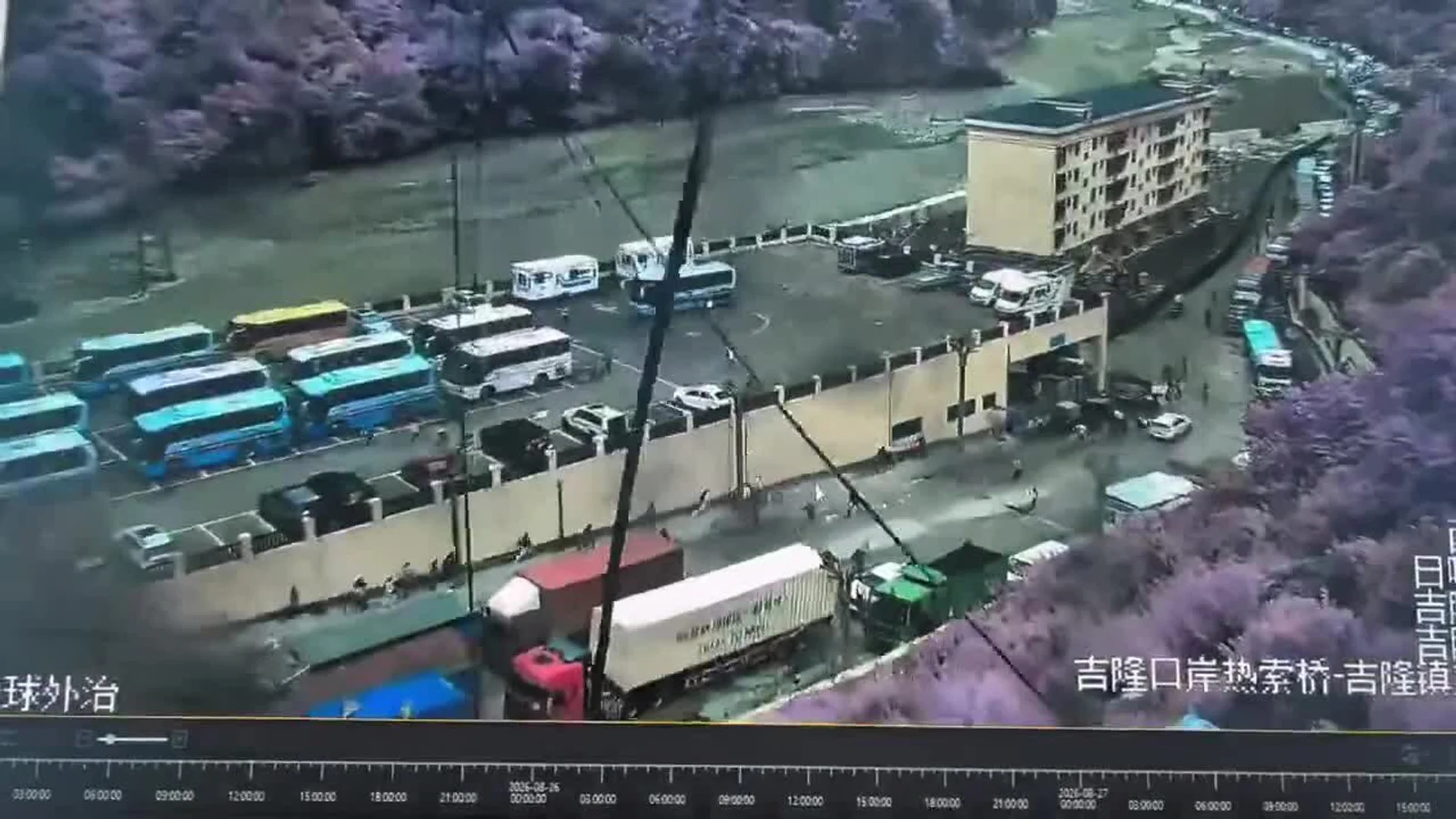 Floodwater and debris surrounding vehicles and buildings at Gyirong Port near the Nepal border